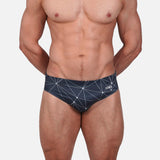 Model wearing Slim Caio Brazilian swim brief in Stellar Ash (dark gray)