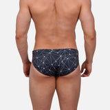 Model wearing Slim Caio Brazilian swim brief in Stellar Ash (dark gray)
