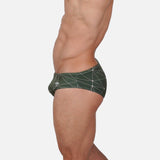 Model wearing Slim Caio Brazilian swim brief in Astro Moss (olive green)