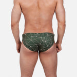 Model wearing Slim Caio Brazilian swim brief in Astro Moss (olive green)