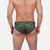 Model wearing Slim Caio Brazilian swim brief in Astro Moss (olive green)