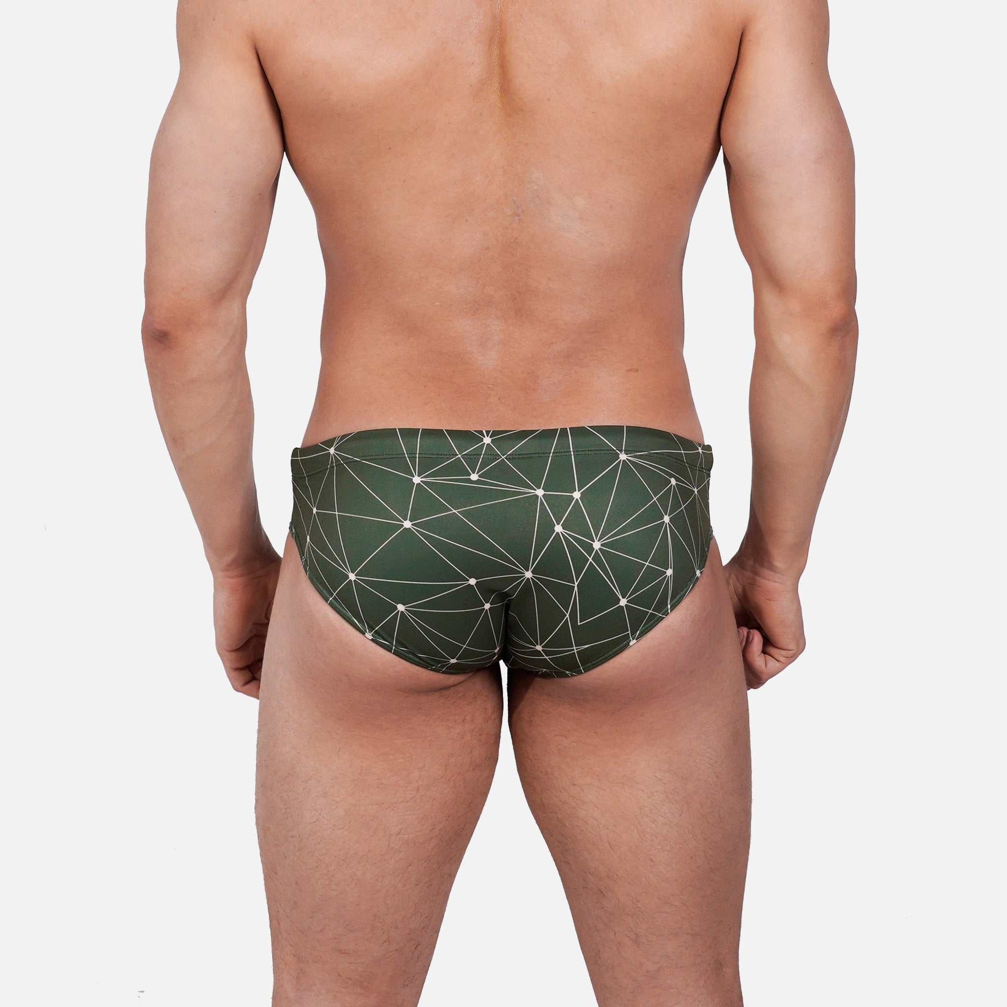Model wearing Slim Caio Brazilian swim brief in Astro Moss (olive green)