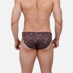 Model wearing Bikini Caio Brazilian swim brief in Astral Soil (Brown)