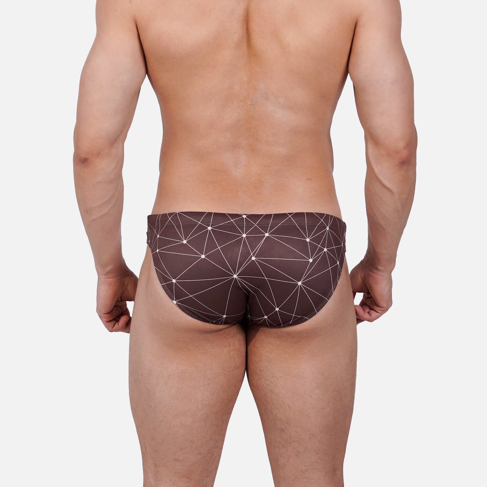 Model wearing Bikini Caio Brazilian swim brief in Astral Soil (Brown)
