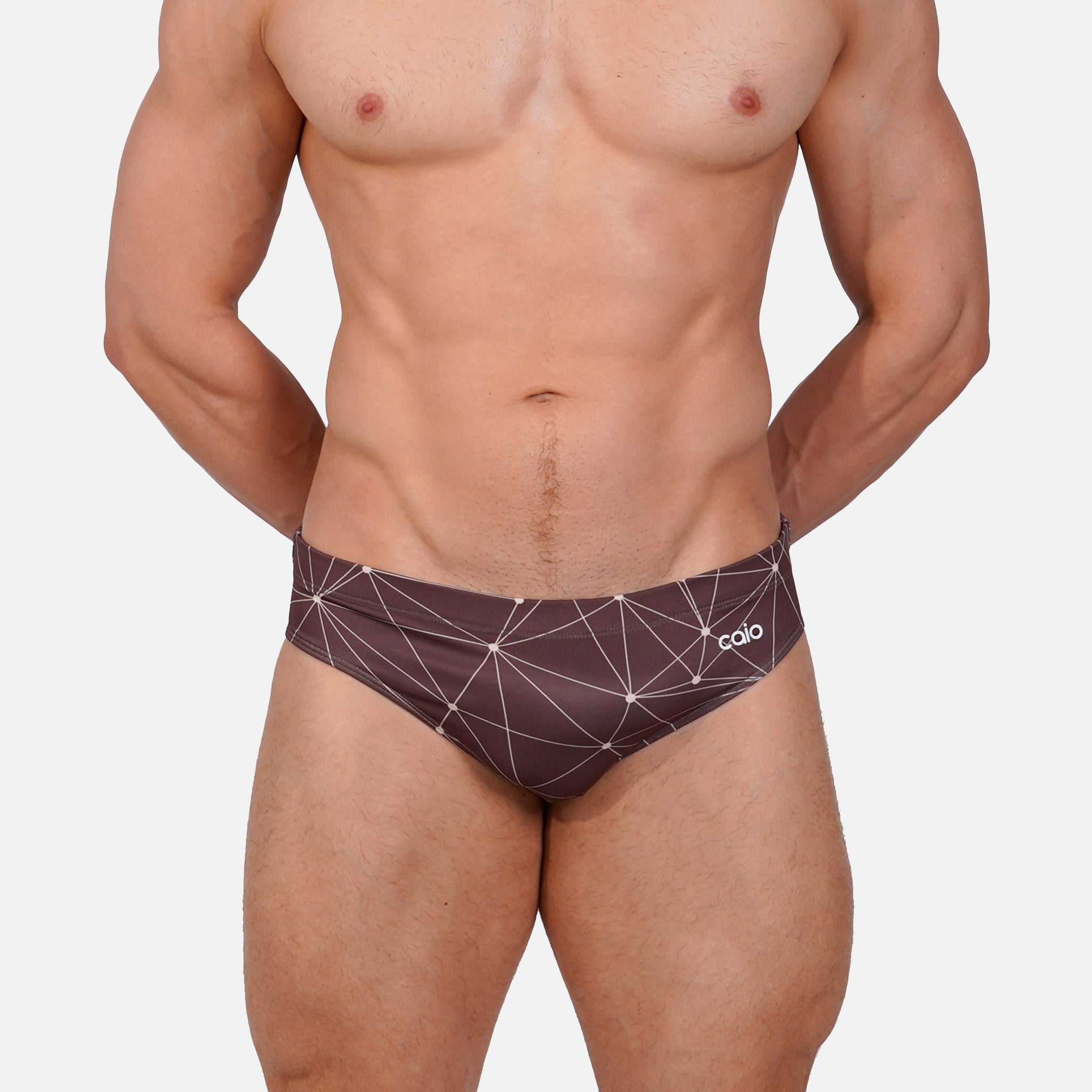 Model wearing Slim Caio Brazilian swim brief in Astral Soil (brown)