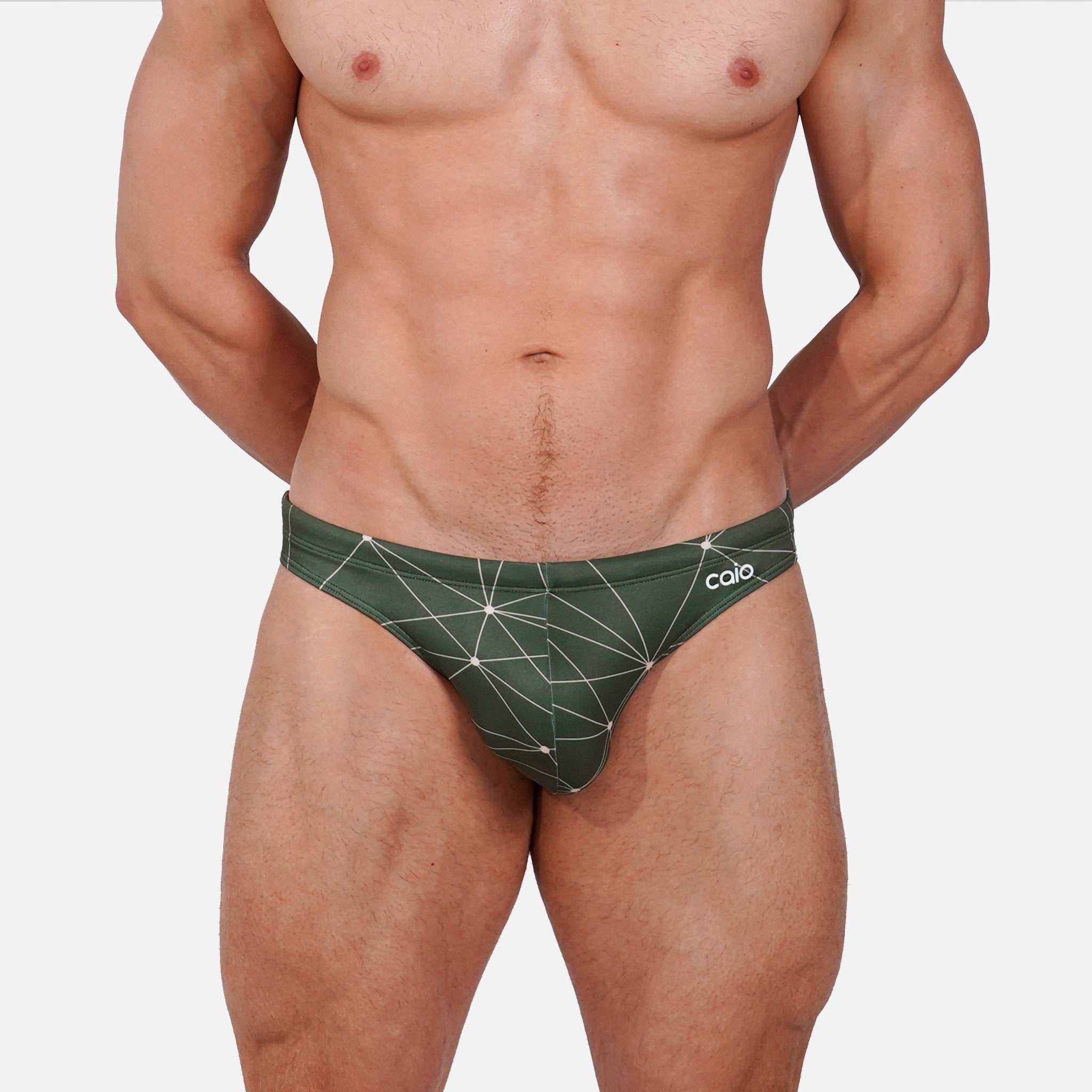 Model wearing Bikini Caio Brazilian swim brief in Astro Moss (olive green)