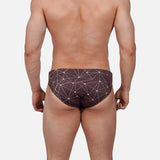 Model wearing Slim Caio Brazilian swim brief in Astral Soil (brown)
