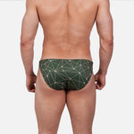 Model wearing Bikini Caio Brazilian swim brief in Astro Moss (olive green)