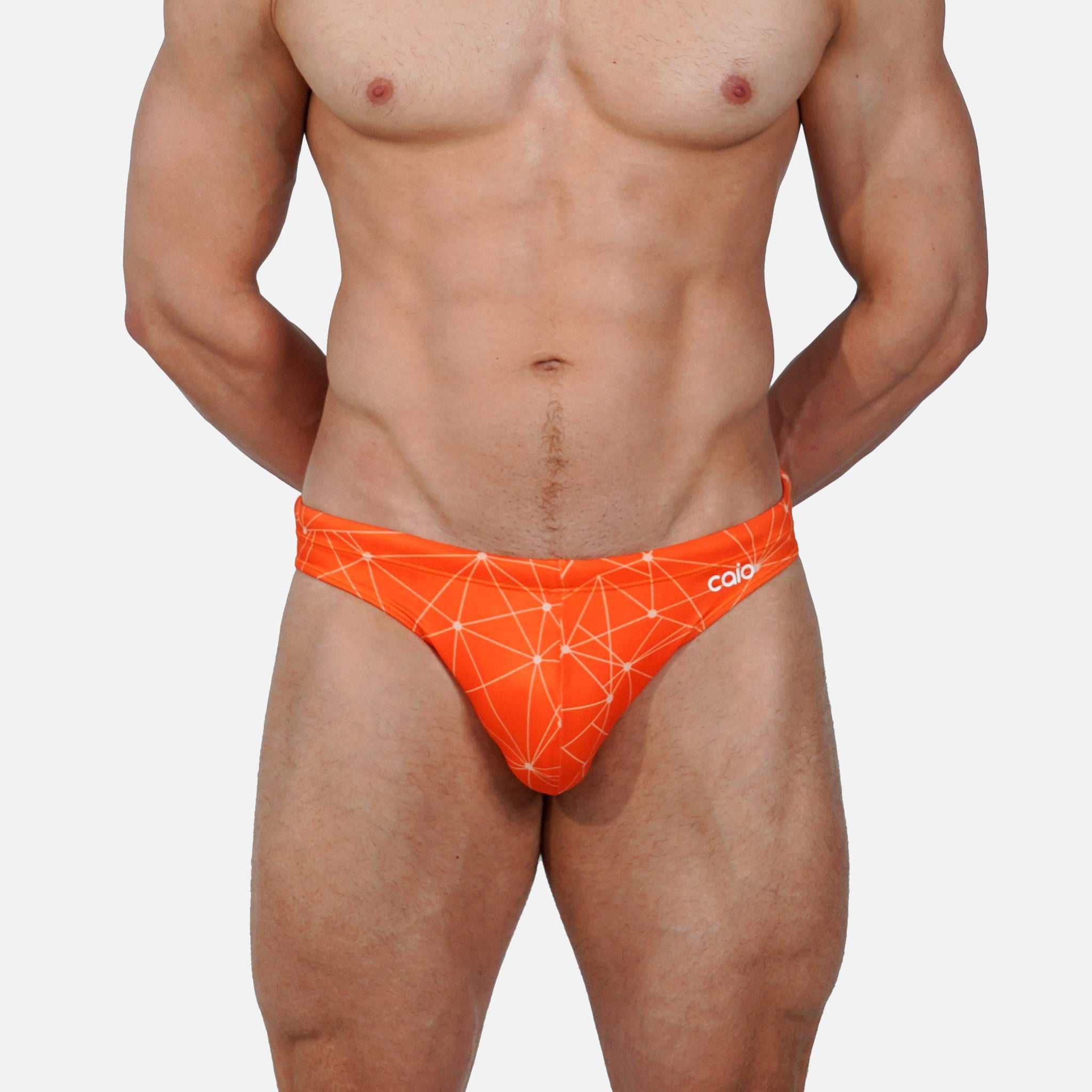 Model wearing Bikini Caio Brazilian swim brief in Solar Flare (orange)