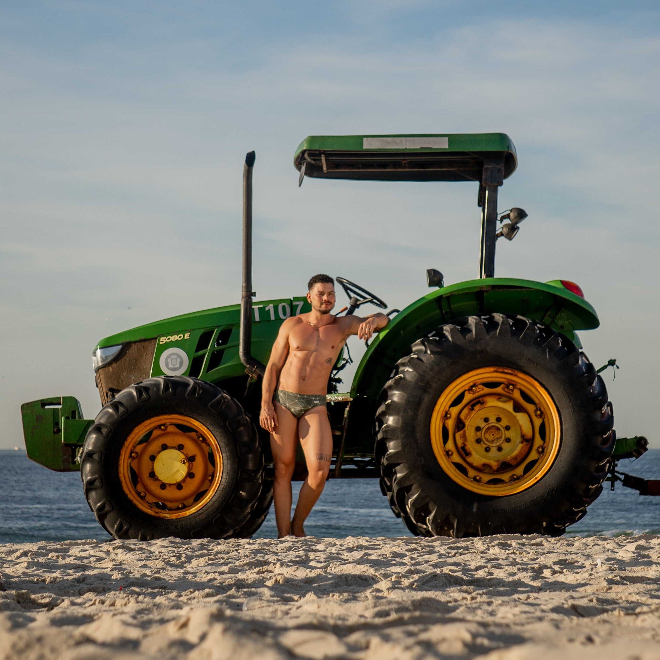 Model wearing Slim Caio Brazilian swim brief in Astro Moss (olive green)