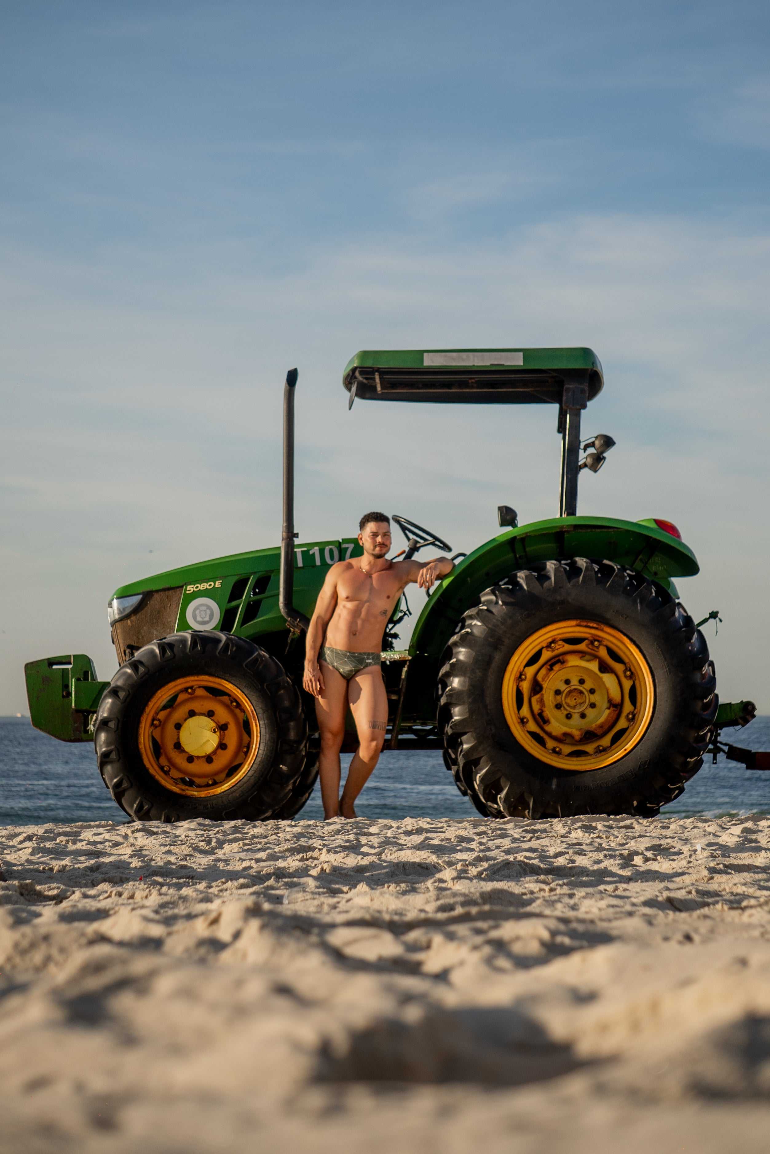 Model wearing Slim Caio Brazilian swim brief in Astro Moss (olive green)