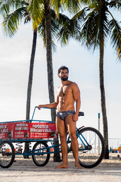 Model wearing Slim Caio Brazilian swim brief in Stellar Ash (dark gray)