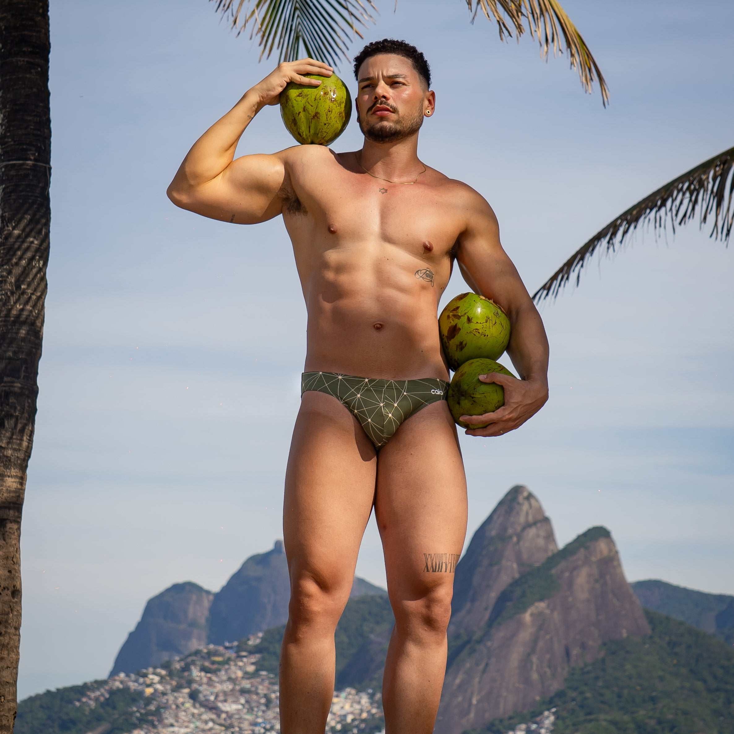Model wearing Bikini Caio Brazilian swim brief in Astro Moss (olive green)