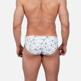 Model wearing Slim Caio Brazilian swim brief in Nova Frost (white)