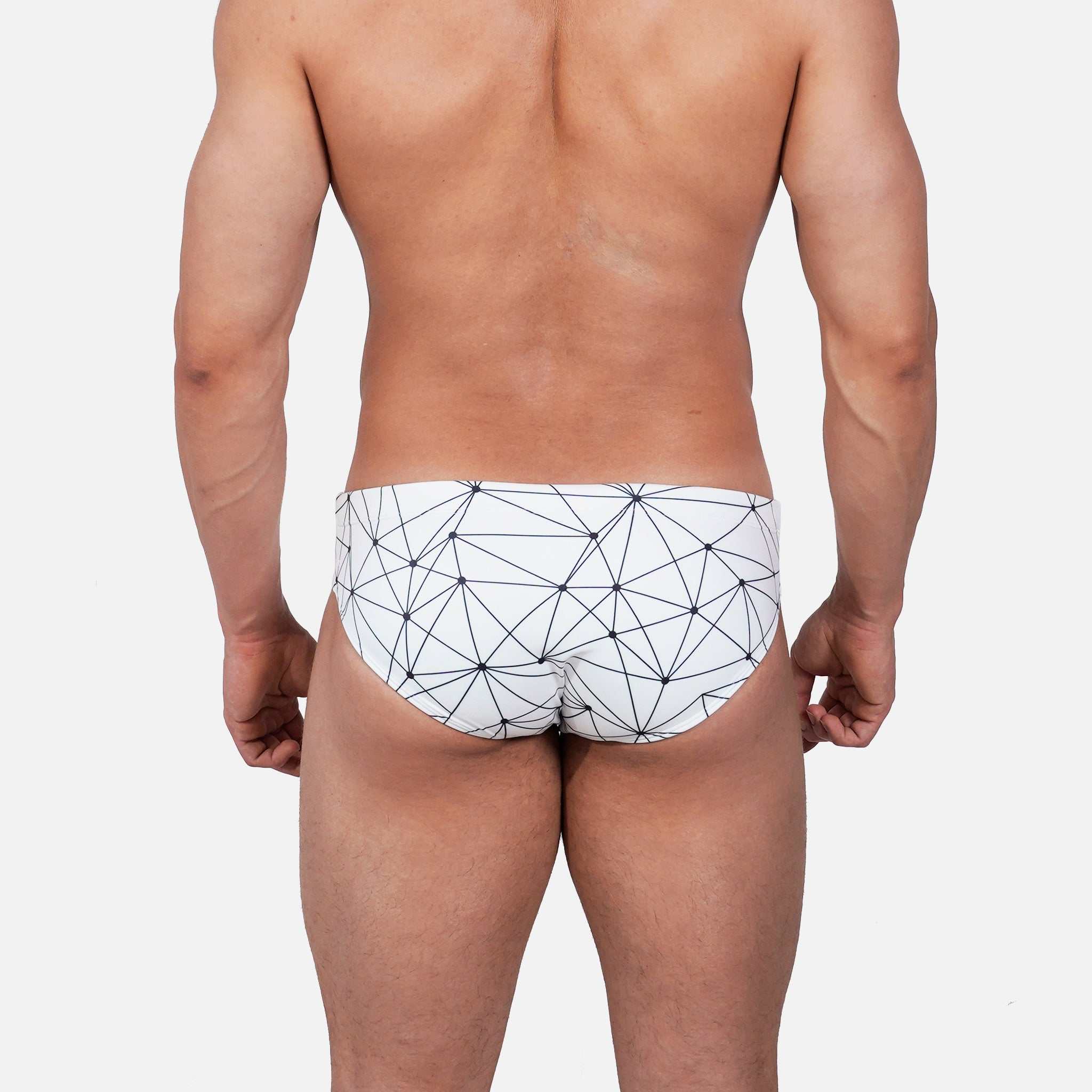 Model wearing Slim Caio Brazilian swim brief in Nova Frost (white)