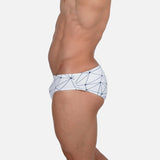 Model wearing Slim Caio Brazilian swim brief in Nova Frost (white)