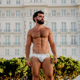 Model wearing caio bikini nova frost swim brief in front of Copacabana Palace.