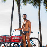 Model wearing Slim Caio Brazilian swim brief in Stellar Ash (dark gray)