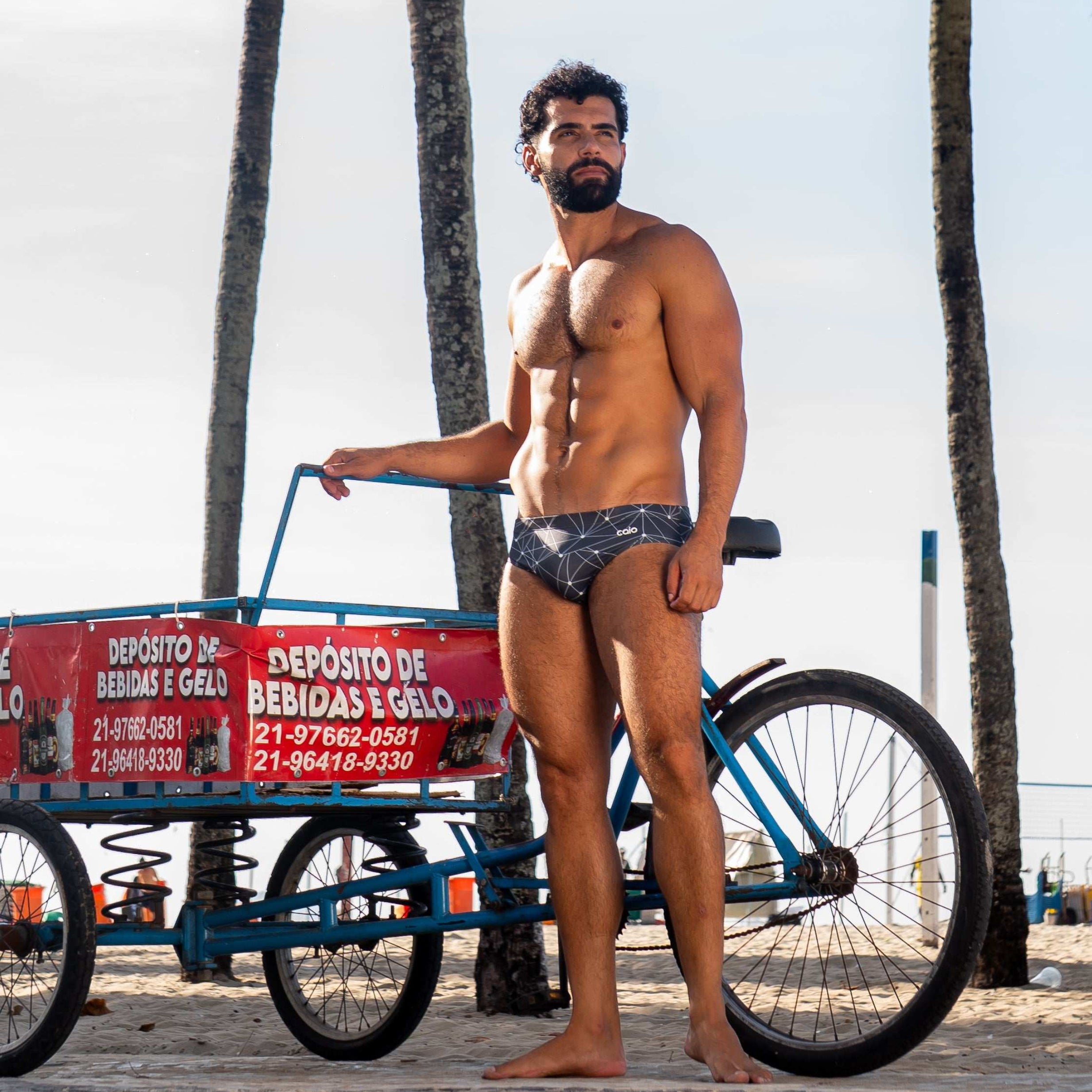 Model wearing Slim Caio Brazilian swim brief in Stellar Ash (dark gray)