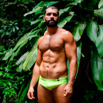 model wearing neon green swim briefs